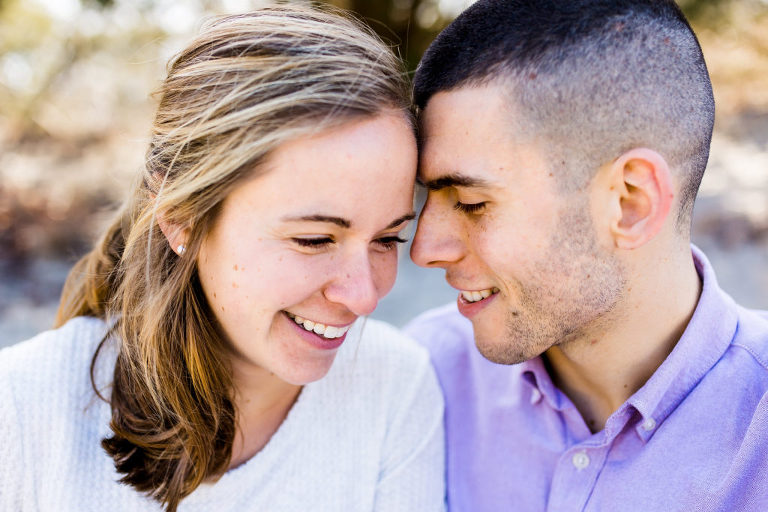 engaged couple snuggle at Corsons Inlet engagement session.