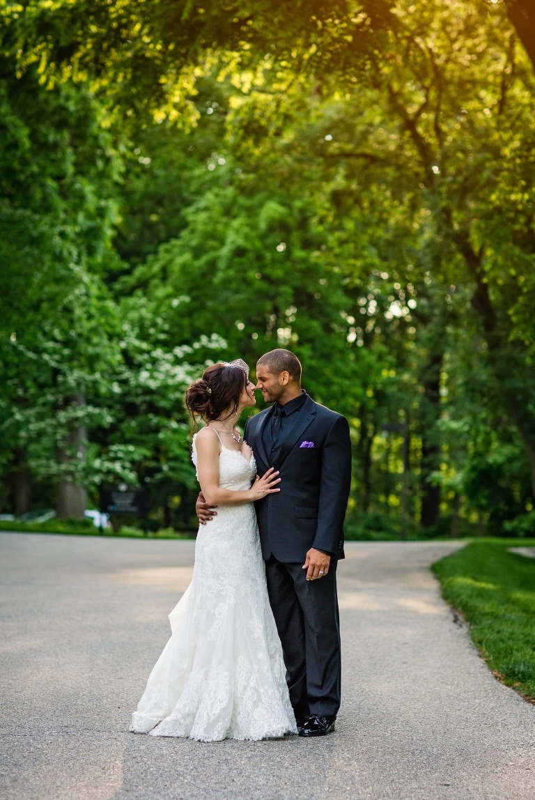 Bride and groom pose in beautiful golden hour light in front of Cairnwood Estate.