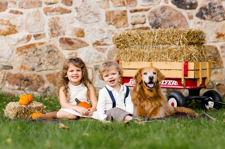 Brother, sister, and dog pose for fall portrait in Bucks County family photography session