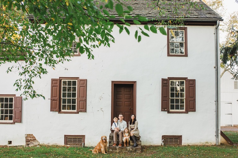 Rustic family portrait in front of house at Washington Crossing Park