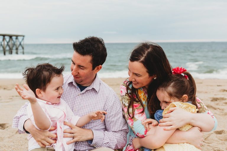 Family shares a candid moment during their family session in Belmar, NJ