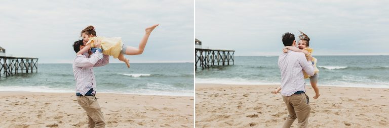 A father swings his little girl in the air at their beach session