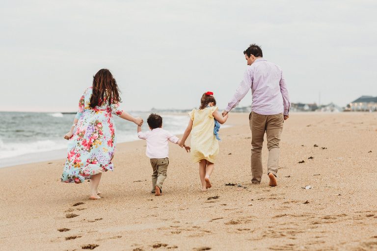 A family walks away on the beach in Belmar, NJ