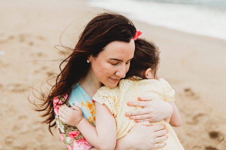 Mom and daughter share a sweet embrace at Belmar family session